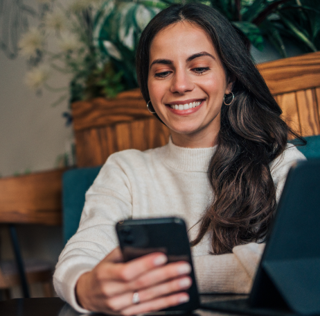 woman smiling looking at her phone